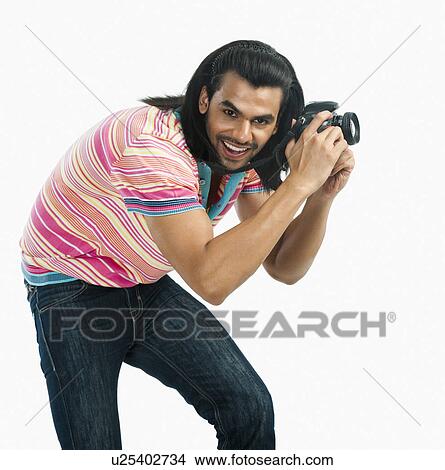 Photographer taking a picture with a digital camera View Large Photo Image Picture - Photographer taking a picture with a digital camera. Fotosearch