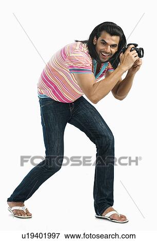 Stock Photo - Photographer taking a picture with a digital camera. Fotosearch