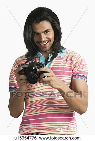 Stock Photograph - Photographer using a digital camera and smiling. Fotosearch