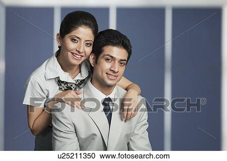 Stock Image - Portrait of a business couple smiling. Fotosearch