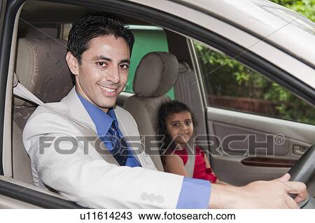 Portrait of a businessman driving a car with his daughter View Large Photo Image Stock Image - Portrait of a businessman driving a car with his daughter. Fotosearch