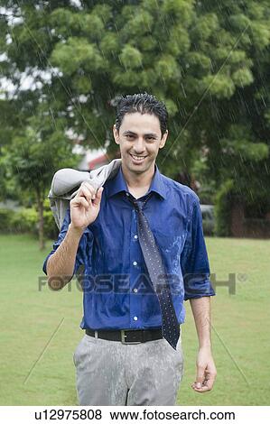 Portrait of a businessman enjoying in rain View Large Photo Image Stock Photo - Portrait of a businessman enjoying in rain. Fotosearch