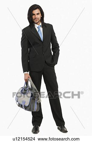 Portrait of a businessman holding a bag View Large Photo Image Picture - Portrait of a businessman holding a bag. Fotosearch