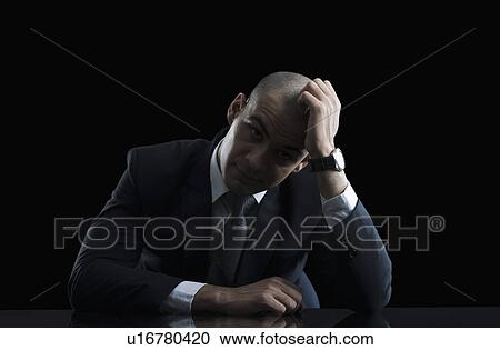 Stock Image - Portrait of a businessman looking worried. Fotosearch