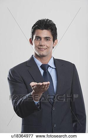 Stock Photo - Portrait of a businessman presenting. Fotosearch