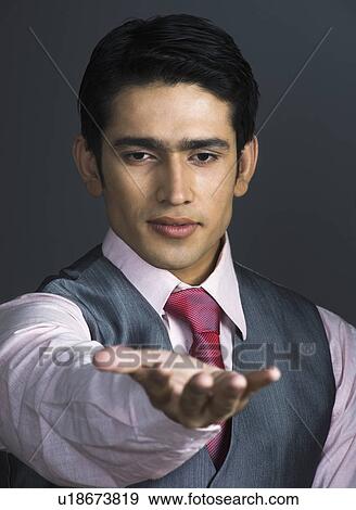 Portrait of a businessman showing his empty palm View Large Photo Image Stock Photo - Portrait of a businessman showing his empty palm. Fotosearch