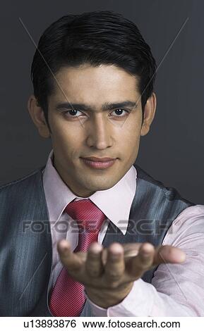 Stock Photograph - Portrait of a businessman showing his empty palm. Fotosearch