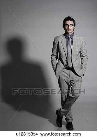 Portrait of a businessman standing with hands in his pockets View Large Photo Image Picture - Portrait of a businessman standing with hands in his pockets. Fotosearch