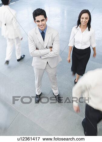 Portrait of a businessman standing with his arms crossed View Large Photo Image Stock Photo - Portrait of a businessman standing with his arms crossed. Fotosearch