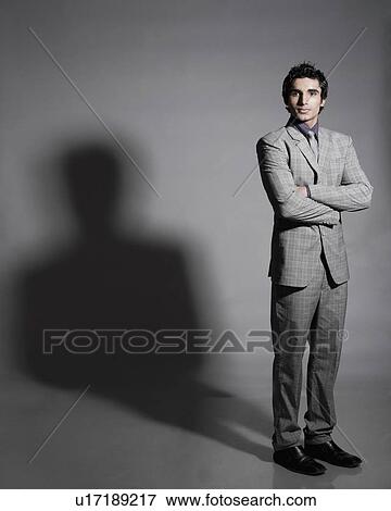Portrait of a businessman standing with his arms crossed View Large Photo Image Stock Photo - Portrait of a businessman standing with his arms crossed. Fotosearch