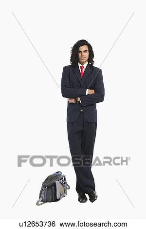 Portrait of a businessman standing with his arms crossed View Large Photo Image Stock Photograph - Portrait of a businessman standing with his arms crossed. Fotosearch