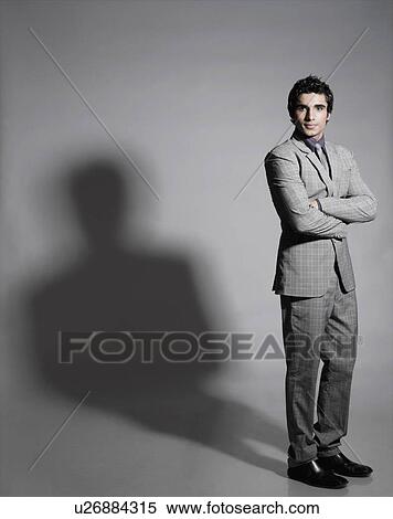 Portrait of a businessman standing with his arms crossed View Large Photo Image Stock Photography - Portrait of a businessman standing with his arms crossed. Fotosearch