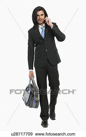 Portrait of a businessman talking on a mobile phone View Large Photo Image Stock Photo - Portrait of a businessman talking on a mobile phone. Fotosearch