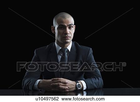 Stock Image - Portrait of a businessman thinking. Fotosearch