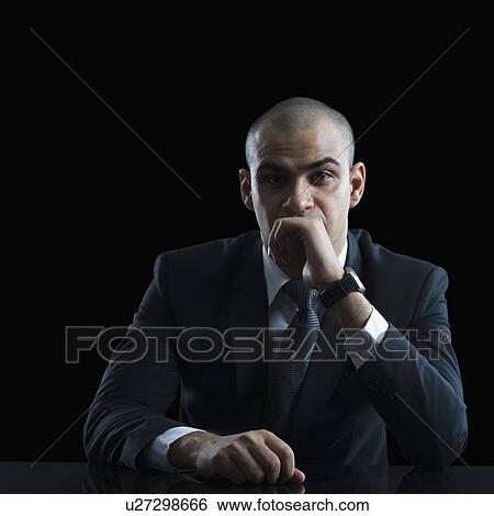 Stock Photograph - Portrait of a businessman thinking. Fotosearch