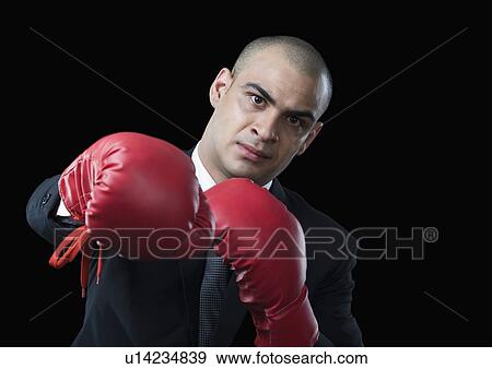 Portrait of a businessman wearing a boxing glove View Large Photo Image Stock Photo - Portrait of a businessman wearing a boxing glove. Fotosearch