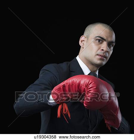 Portrait of a businessman wearing a boxing glove View Large Photo Image Stock Photo - Portrait of a businessman wearing a boxing glove. Fotosearch
