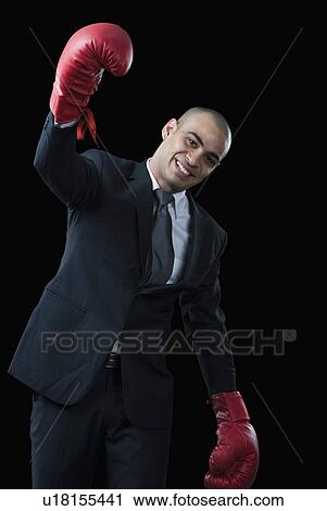 Portrait of a businessman wearing boxing gloves and smiling View Large Photo Image Stock Image - Portrait of a businessman wearing boxing gloves and smiling. Fotosearch