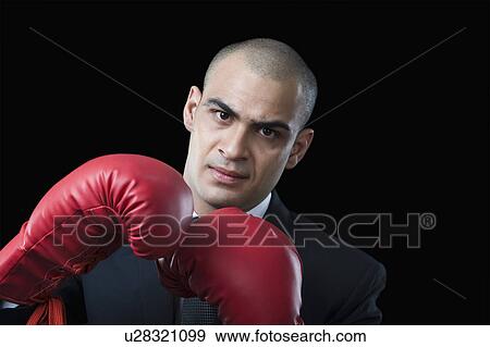Portrait of a businessman wearing boxing gloves View Large Photo Image Stock Photo - Portrait of a businessman wearing boxing gloves. Fotosearch