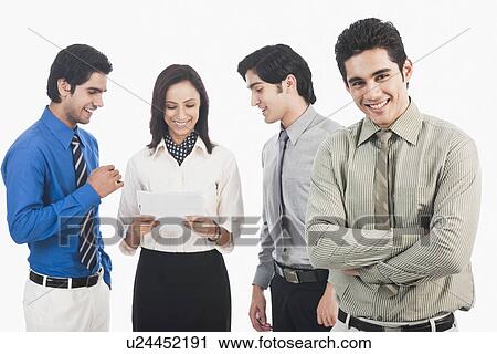 Portrait of a businessman with his colleagues discussing in the background View Large Photo Image Stock Image - Portrait of a businessman with his colleagues discussing in the background. Fotosearch