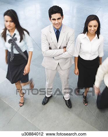 Stock Image - Portrait of a businessman with his colleagues. Fotosearch