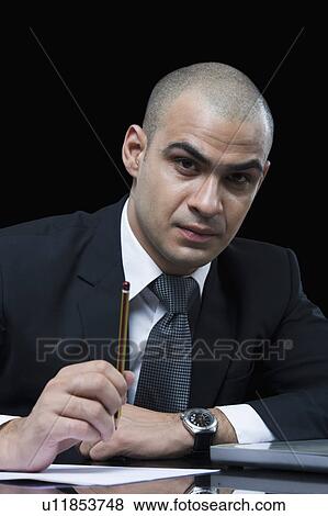 Portrait of a businessman working in front of a laptop View Large Photo Image Stock Photo - Portrait of a businessman working in front of a laptop. Fotosearch