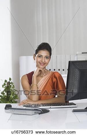 Stock Image - Portrait of a businesswoman in an office. Fotosearch