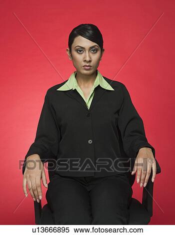 Portrait of a businesswoman sitting on a chair View Large Photo Image Stock Photography - Portrait of a businesswoman sitting on a chair. Fotosearch