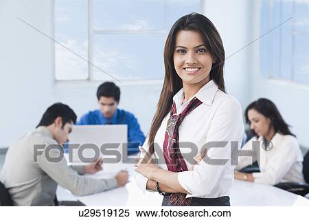 Portrait of a businesswoman smiling with her colleague View Large Photo Image Stock Photography - Portrait of a businesswoman smiling with her colleague. Fotosearch