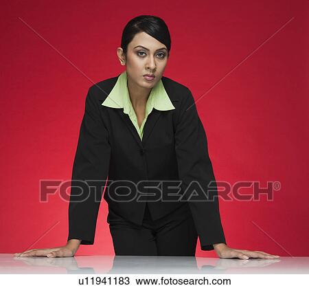 Portrait of a businesswoman standing at a conference table View Large Photo Image Stock Image - Portrait of a businesswoman standing at a conference table. Fotosearch