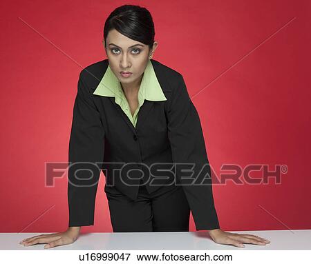 Portrait of a businesswoman standing at a conference table View Large Photo Image Stock Photo - Portrait of a businesswoman standing at a conference table. Fotosearch