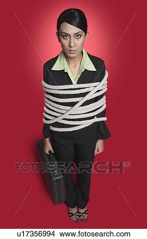Portrait of a businesswoman tied up with rope View Large Photo Image Picture - Portrait of a businesswoman tied up with rope. Fotosearch