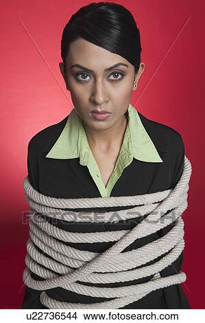 Portrait of a businesswoman tied up with rope View Large Photo Image Picture - Portrait of a businesswoman tied up with rope. Fotosearch