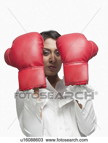 Portrait of a businesswoman wearing boxing gloves View Large Photo Image Stock Image - Portrait of a businesswoman wearing boxing gloves. Fotosearch