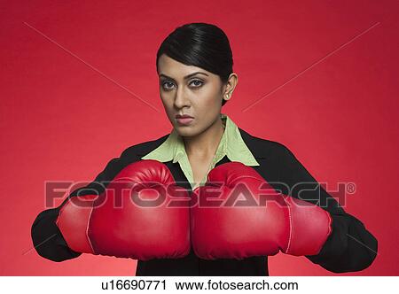Portrait of a businesswoman wearing boxing gloves View Large Photo Image Stock Image - Portrait of a businesswoman wearing boxing gloves. Fotosearch