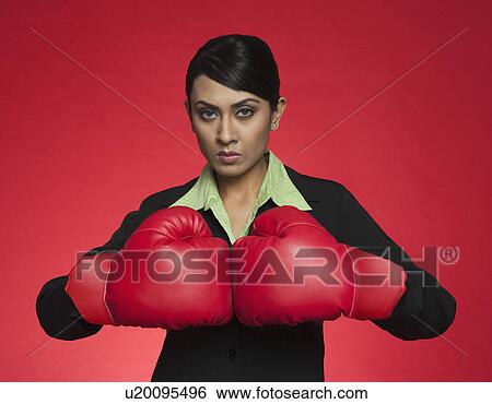 Portrait of a businesswoman wearing boxing gloves View Large Photo Image Stock Photograph - Portrait of a businesswoman wearing boxing gloves. Fotosearch