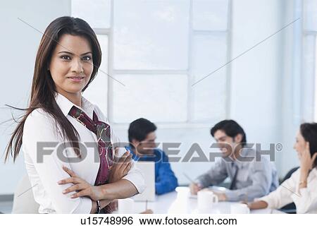 Portrait of a businesswoman with her colleagues View Large Photo Image Stock Photograph - Portrait of a businesswoman with her colleagues. Fotosearch