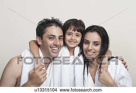 Portrait of a couple smiling with their daughter View Large Photo Image Picture - Portrait of a couple smiling with their daughter. Fotosearch