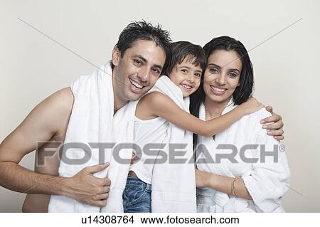 Picture - Portrait of a couple smiling with their daughter. Fotosearch