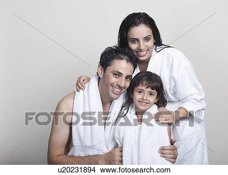 Portrait of a couple smiling with their daughter View Large Photo Image Picture - Portrait of a couple smiling with their daughter. Fotosearch