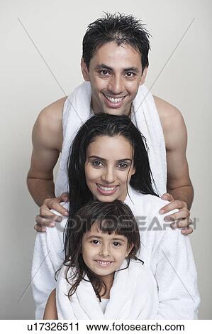 Portrait of a couple smiling with their daughter View Large Photo Image Stock Image - Portrait of a couple smiling with their daughter. Fotosearch