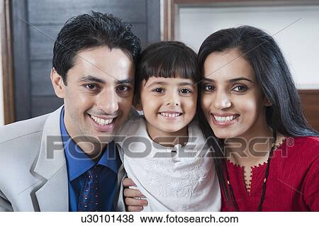 Portrait of a couple smiling with their daughter View Large Photo Image Stock Photo - Portrait of a couple smiling with their daughter. Fotosearch