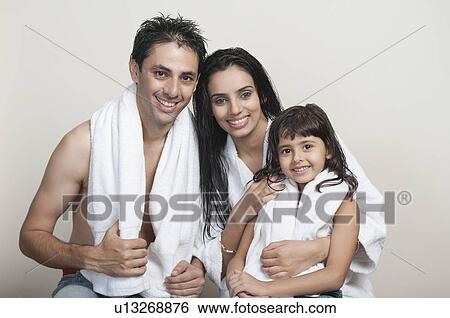 Portrait of a couple smiling with their daughter View Large Photo Image Stock Photograph - Portrait of a couple smiling with their daughter. Fotosearch