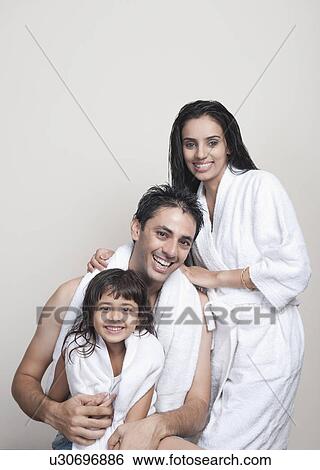 Portrait of a couple smiling with their daughter View Large Photo Image Stock Photograph - Portrait of a couple smiling with their daughter. Fotosearch