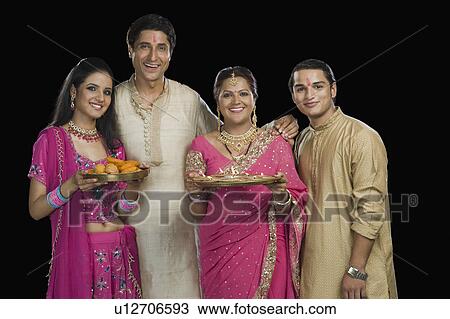 Portrait of a family standing in traditional Indian clothing View Large Photo Image Stock Image - Portrait of a family standing in traditional Indian clothing. Fotosearch