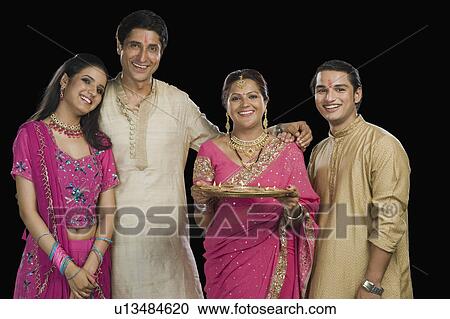 Portrait of a family standing in traditional Indian clothing View Large Photo Image Stock Image - Portrait of a family standing in traditional Indian clothing. Fotosearch