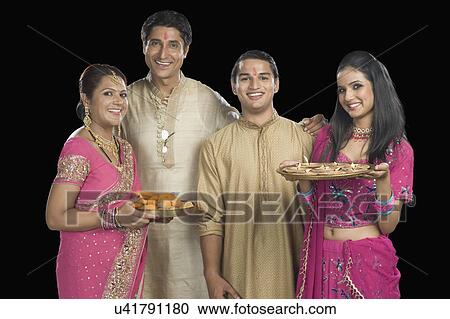 Portrait of a family standing in traditional Indian clothing View Large Photo Image Stock Image - Portrait of a family standing in traditional Indian clothing. Fotosearch