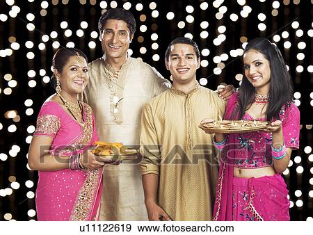 Portrait of a family standing in traditional Indian clothing View Large Photo Image Stock Photo - Portrait of a family standing in traditional Indian clothing. Fotosearch