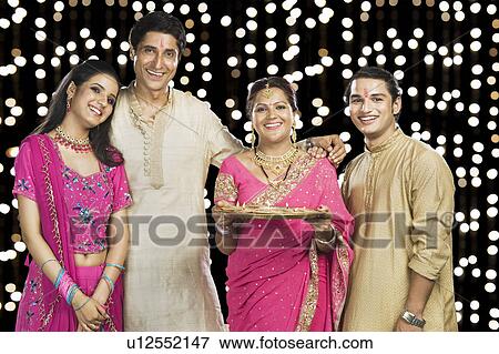 Stock Photo - Portrait of a family standing in traditional Indian clothing. Fotosearch