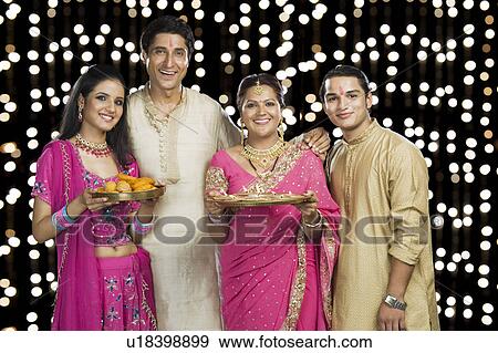 Stock Photo - Portrait of a family standing in traditional Indian clothing. Fotosearch